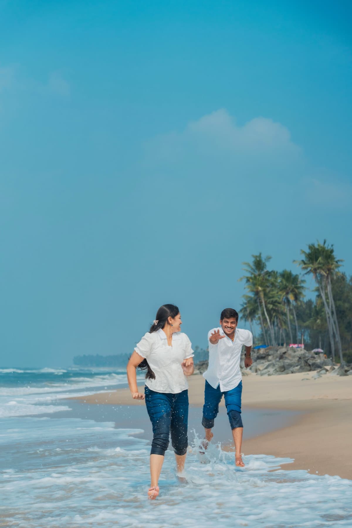 Couple running along the shore
