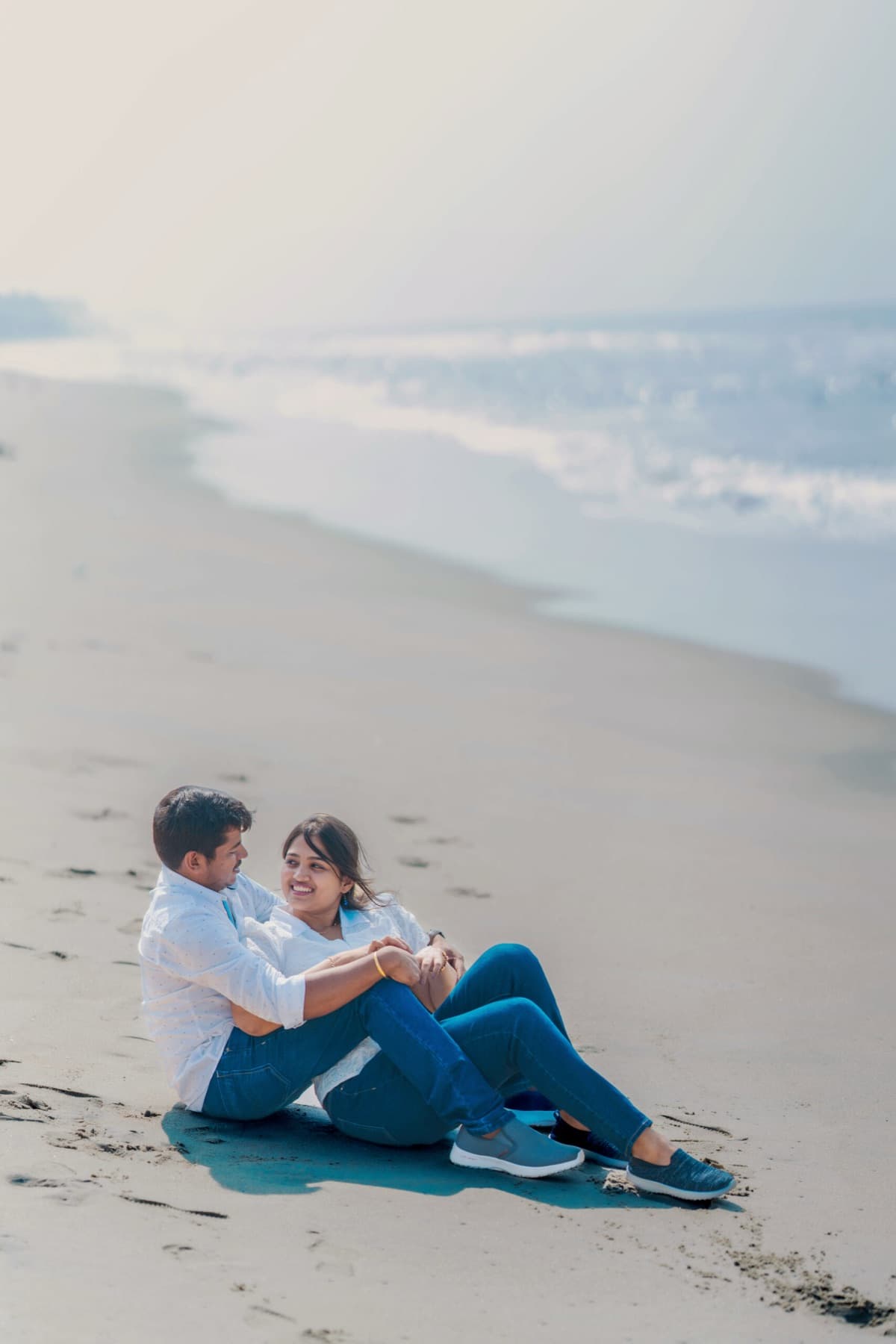 Couple relaxing together on the sand