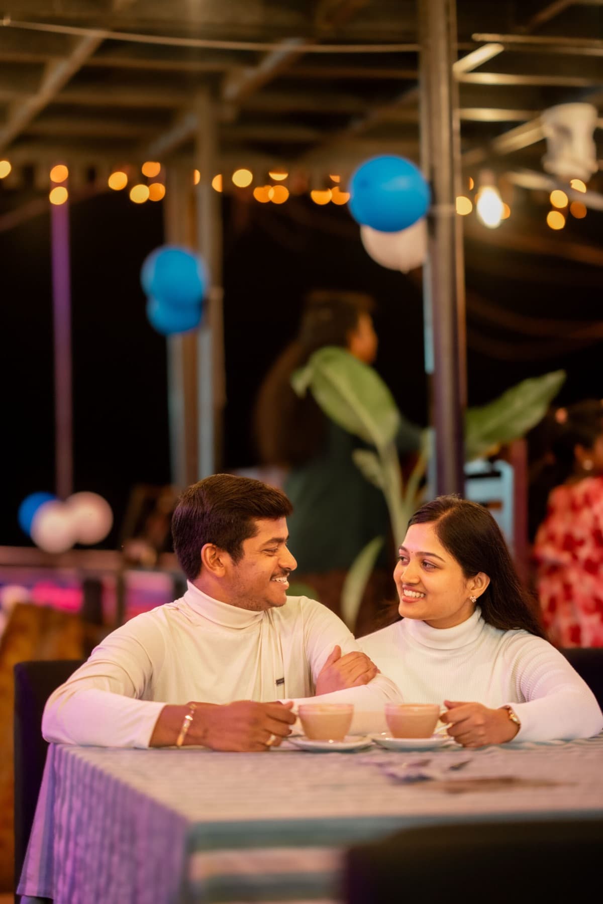 Couple at a cafe table during a pre-wedding shoot in Coimbatore