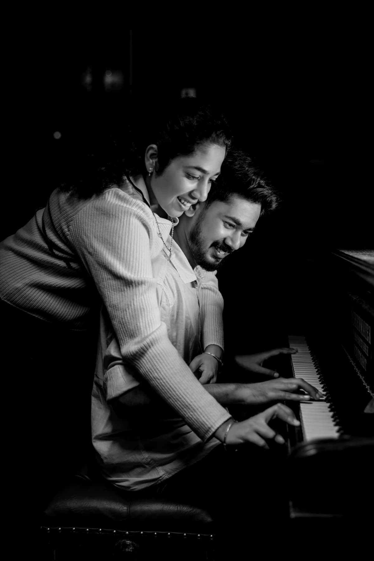 Black and white photo of a couple at a piano