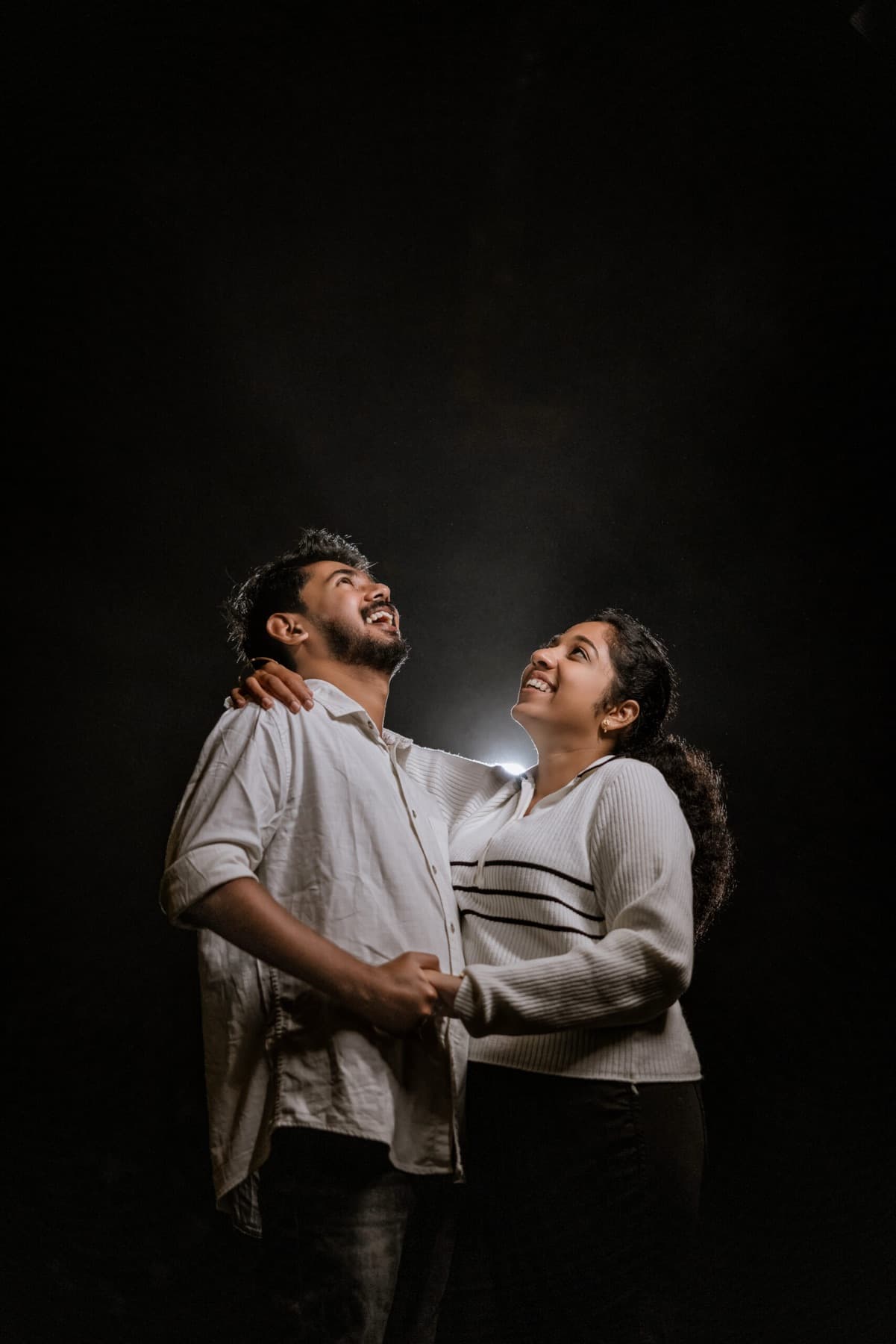 Couple studio portrait with dramatic lighting