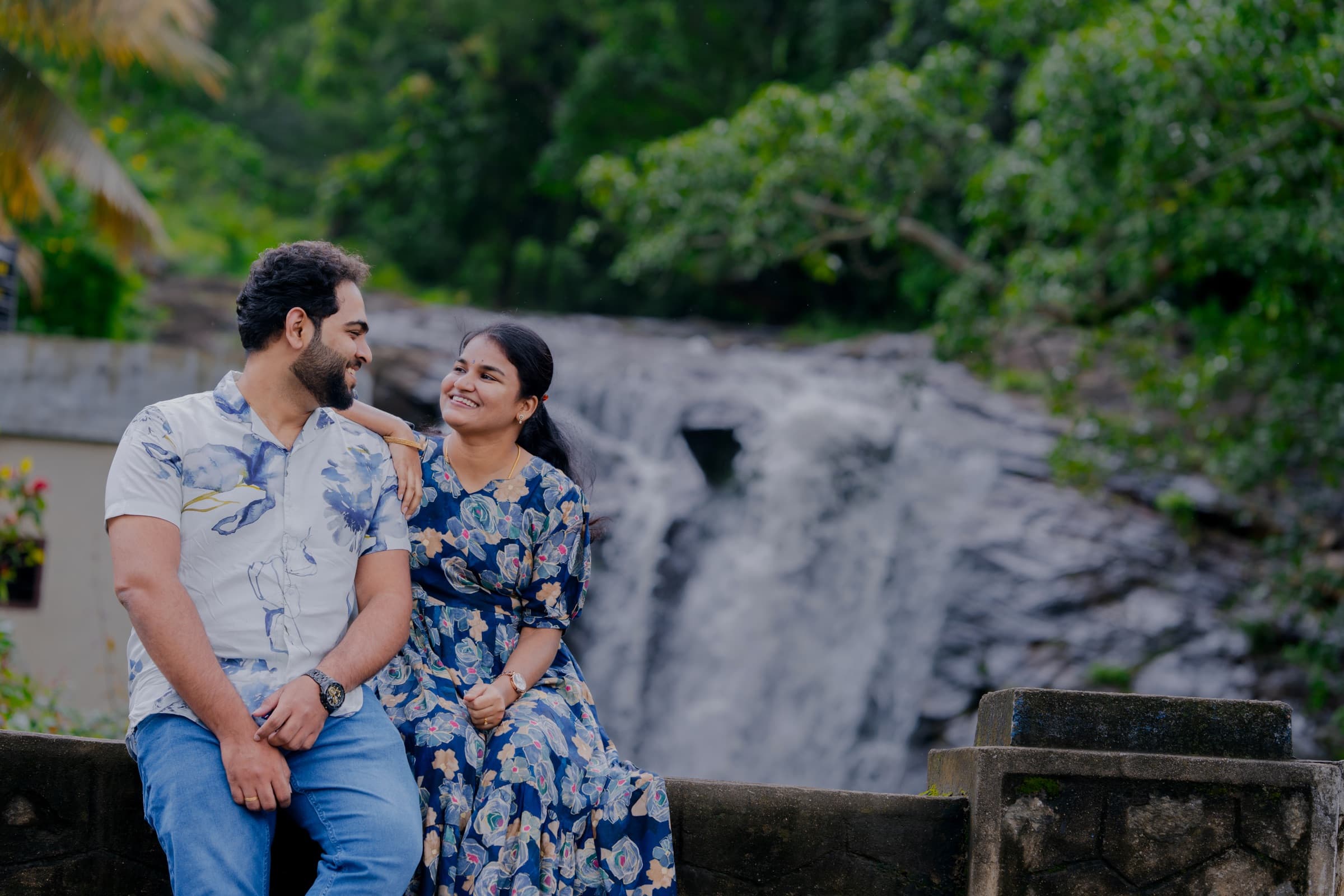 Couple sitting at a waterfall viewpoint