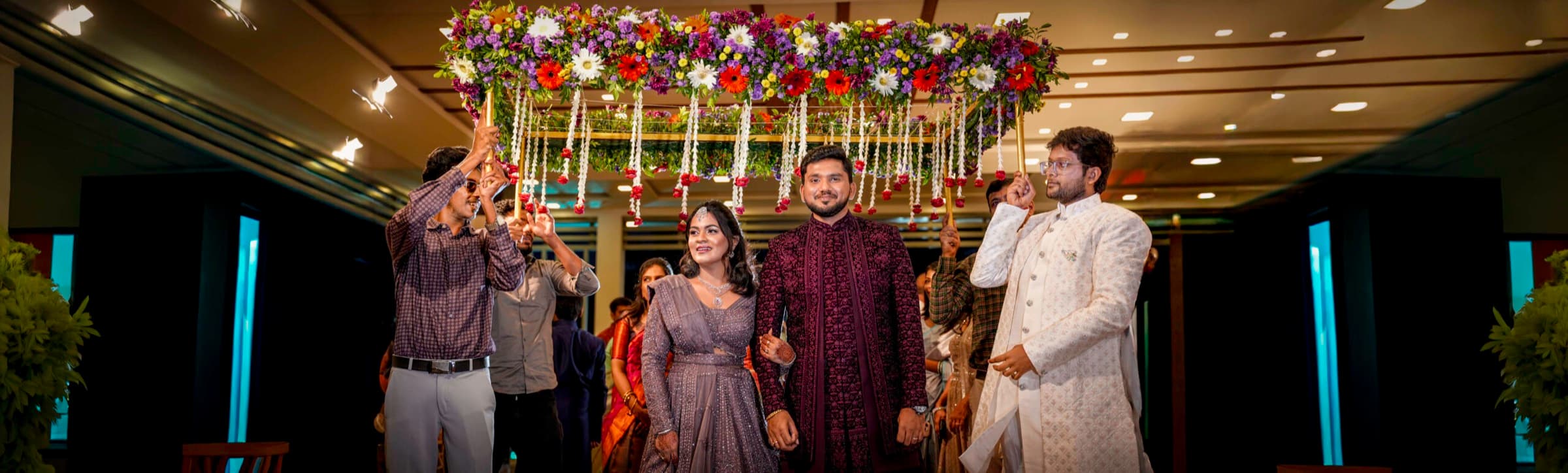 Couple and guests at a decorated reception stage