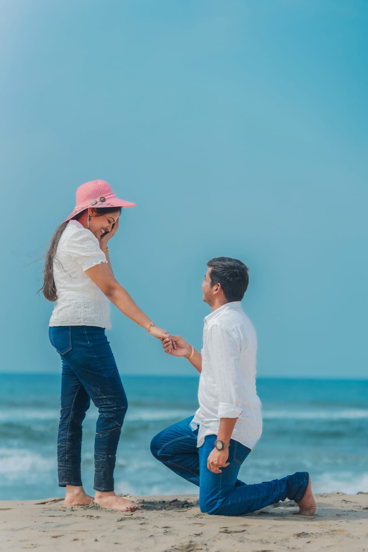 Groom proposing on one knee during a beach pre-wedding shoot