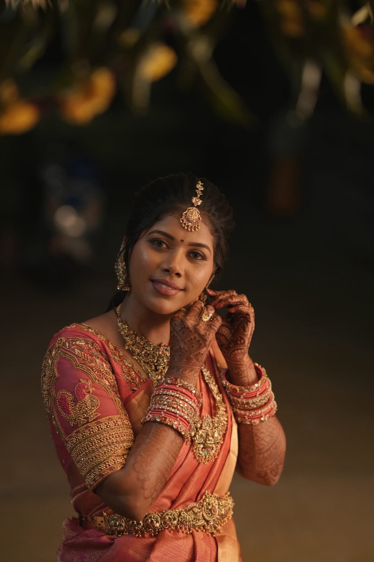 Bridal portrait in golden evening light wearing a pink silk saree and jewellery