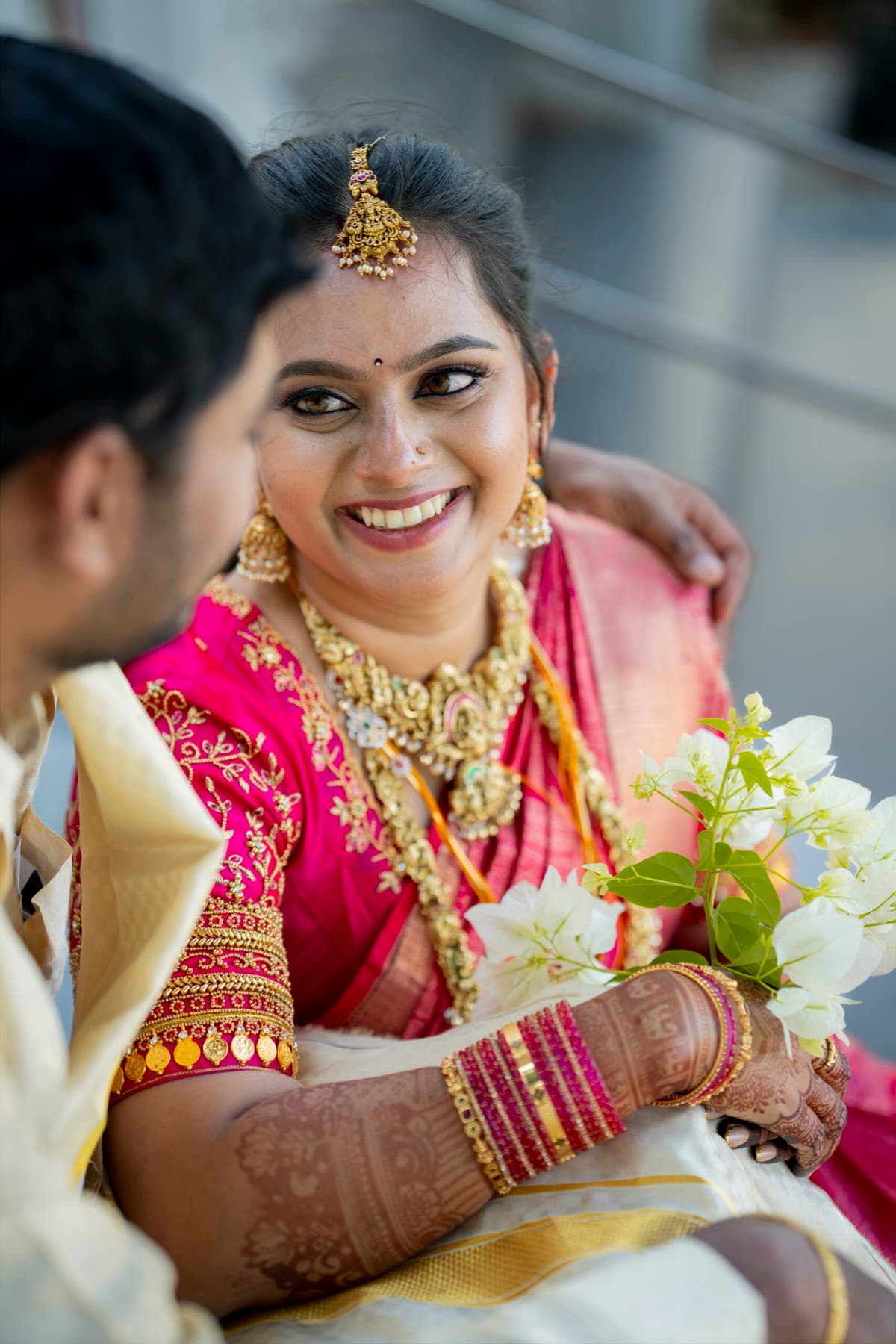 Candid moment of a laughing bride with her groom at a Tamil wedding