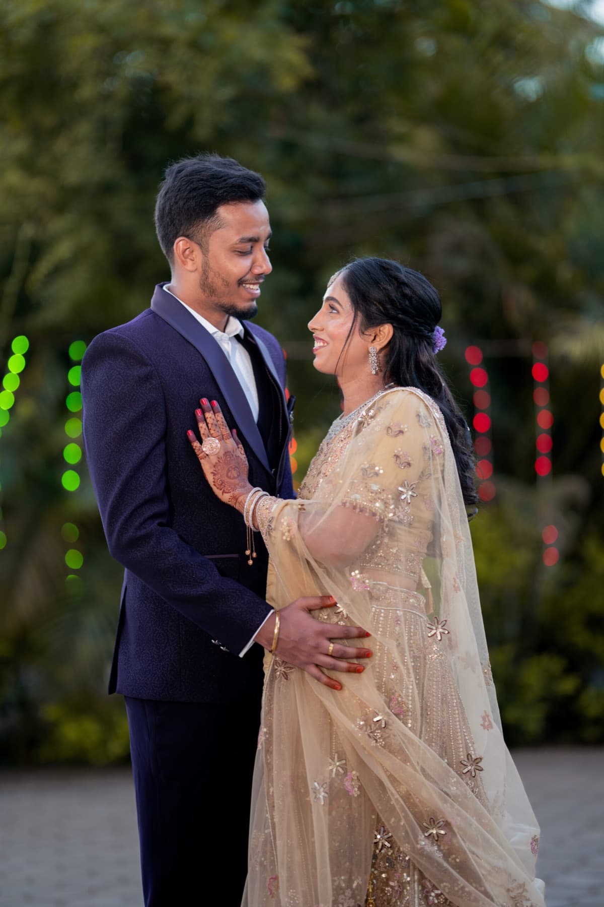 Couple in a suit and lehenga at their evening reception
