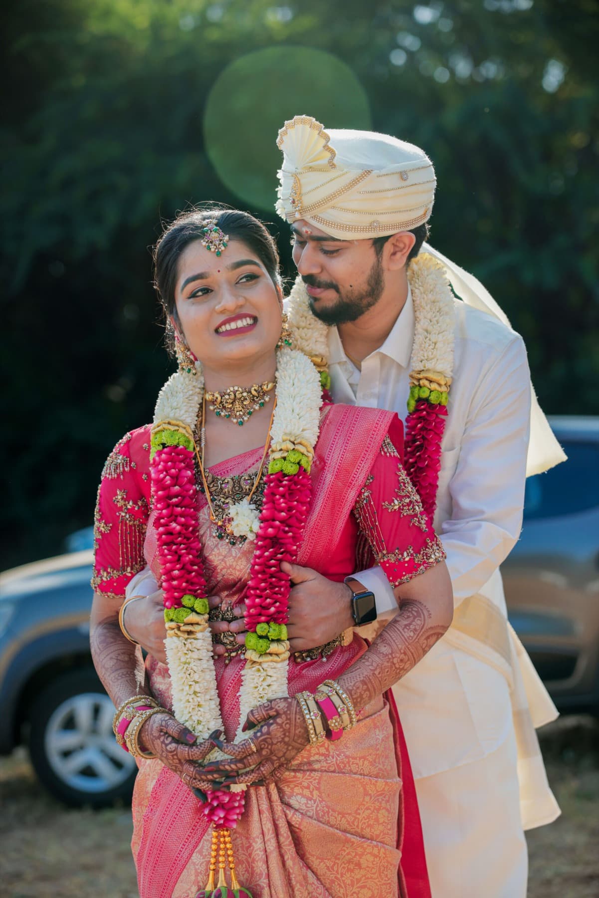 Bride and groom in jasmine garlands smiling together on their wedding day in Coimbatore